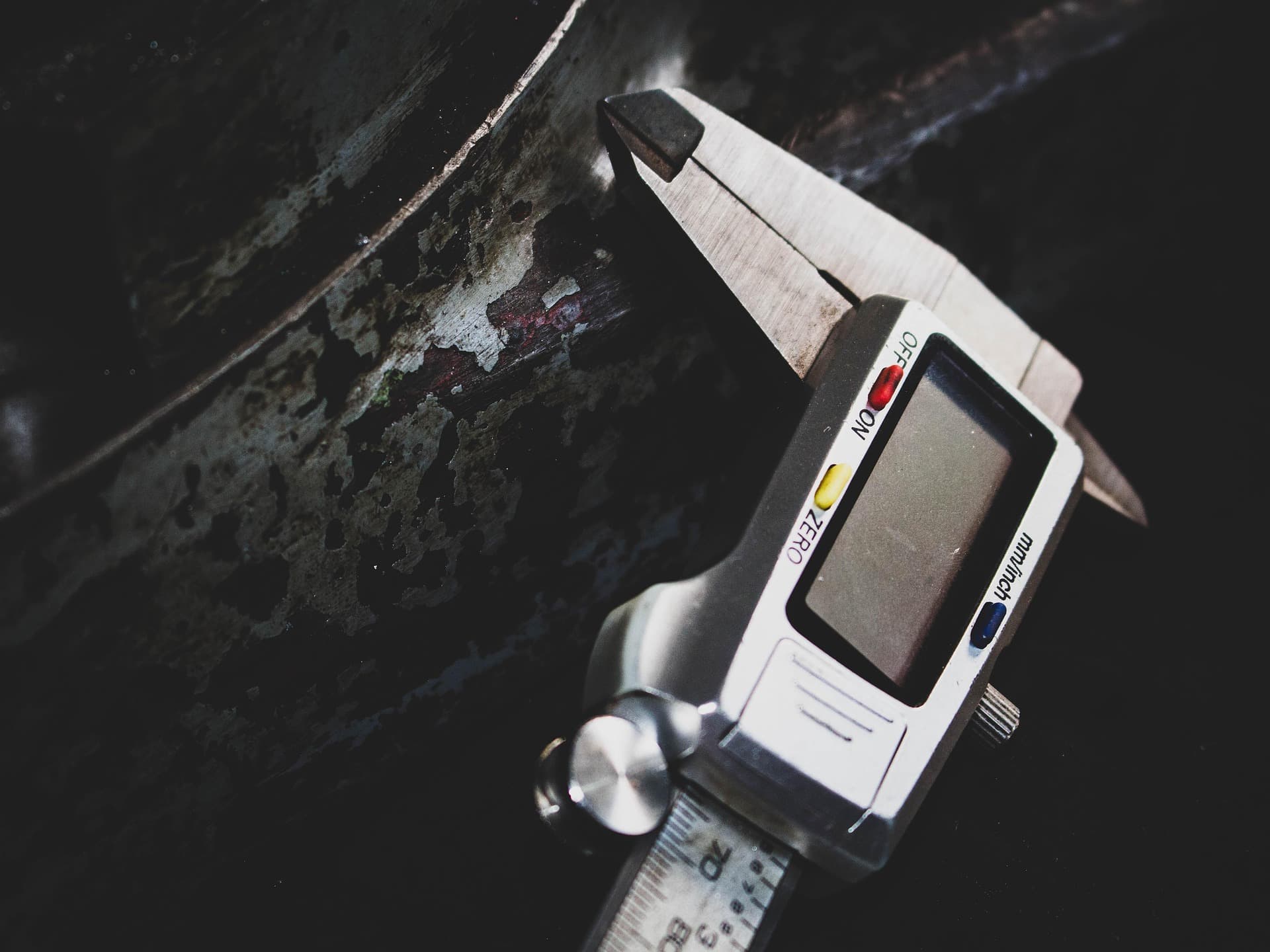 Digital caliper beside a metal component